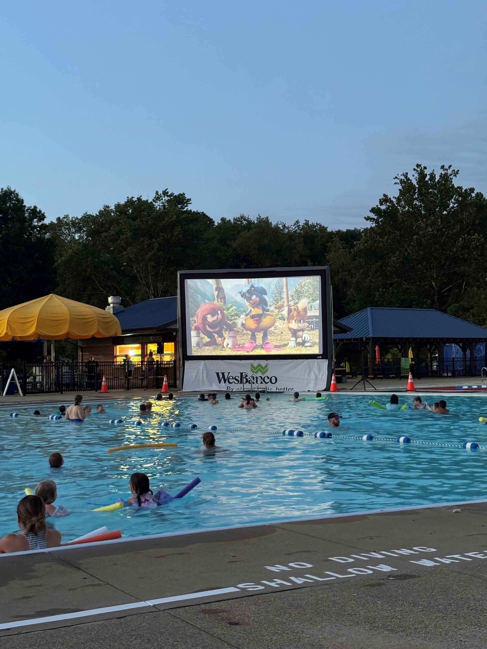 Movie screen set up at the pool for a Float with a Flick